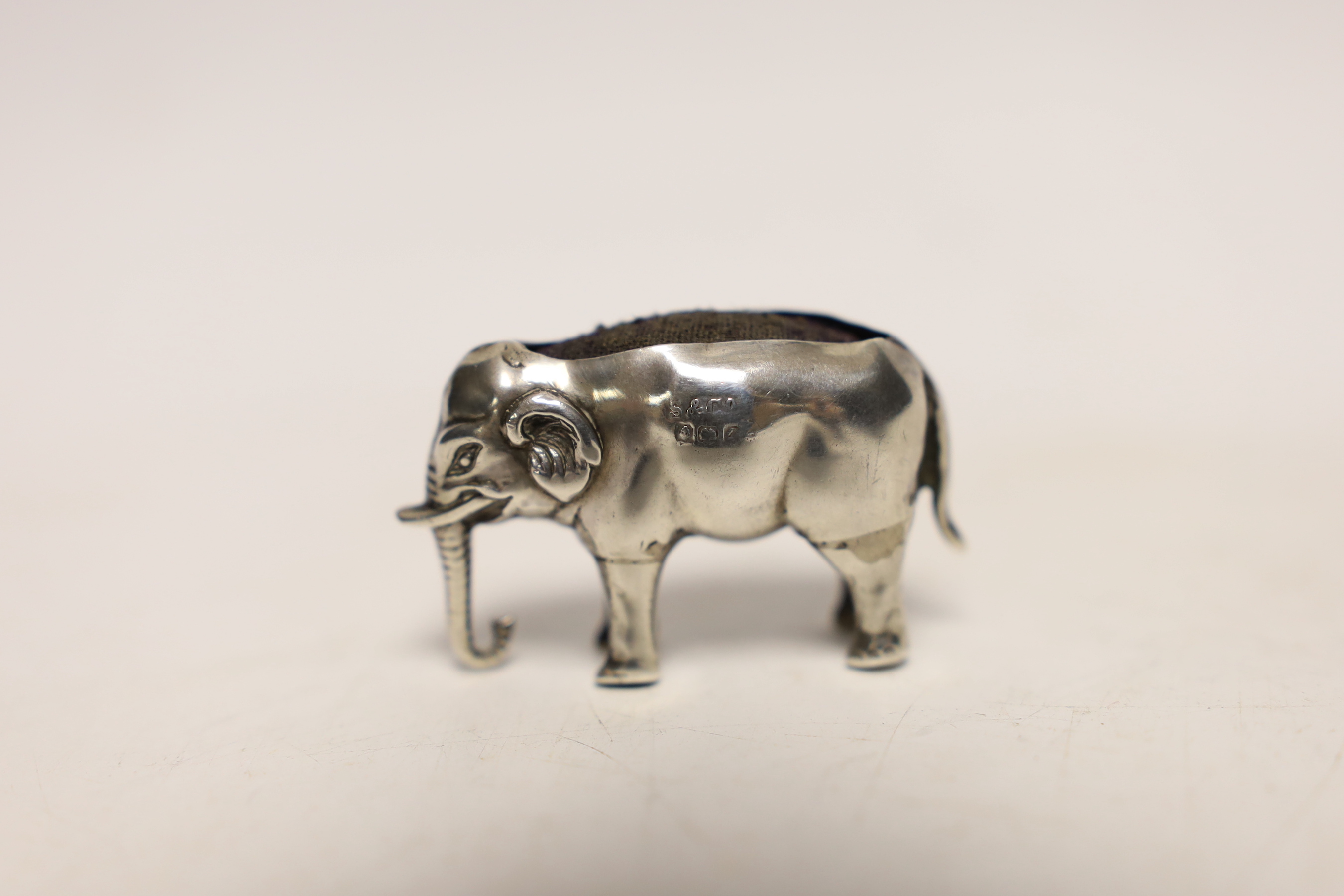 An early 20th century novelty silver pin cushion, modelled as a small elephant, Sydney & Co, Birmingham, date letter rubbed, 42mm.